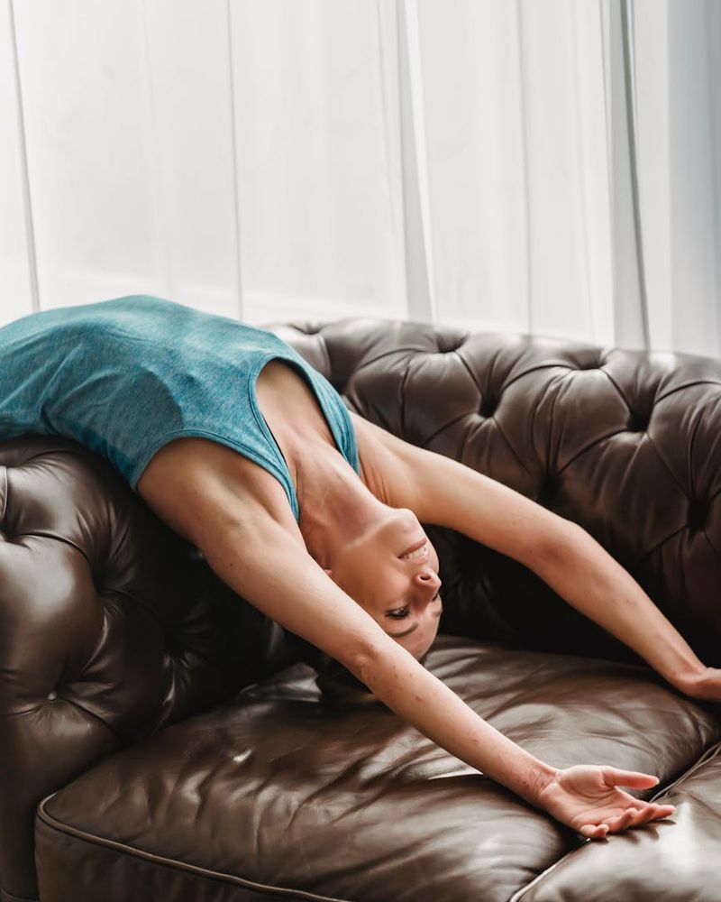 Person doing a slow arm stretch in a dark room