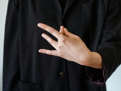Person hands in a mudra position during meditation