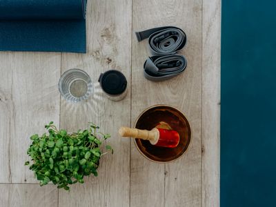 Yoga blocks and strap on a wooden floor